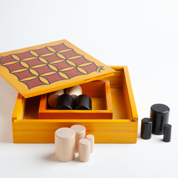 Gobblet! is a fast-paced game that is easy to learn. The objective is to get four pieces in a row, which is surprisingly challenging as your opponent can claim your spot by covering your piece with a larger one. Wooden playing board. 
