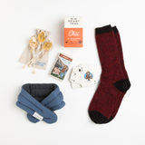 Thick alpaca socks, a heated neck wrap, Smokey Bear playing cards, and a warming blend of chai tea provide the means to appreciate the great outdoors from the comfort of a couch.