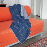 Plush flannel blanket:  Indigo and grey "squared" reversible blanket by David Fussenegger is made in Austria at a company that has been producing premium textiles since 1832. Dimensions: 55 x 79 inches. Washable cotton blend. 