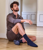 Man wearing non-slip Falke cuddle pads in asphalt