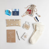 Carton Ivory - Get well essentials that will lift any patient's comfort level up a notch. A lavender-scented eye pillow, ridiculously cozy socks, rosy lip tint, organic facial wipes, elegant playing cards, and more, round out our best-selling care package.