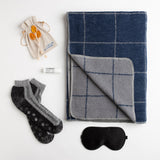 In rich shades of indigo and grey, this reversible blanket from David Fussenegger is destined to be a favorite. Combined with a black silk eye mask, alpaca non-slip socks, soothing lip balm, and clover honey spoons, this wellness gift is sure to make anyone feel more comfortable.