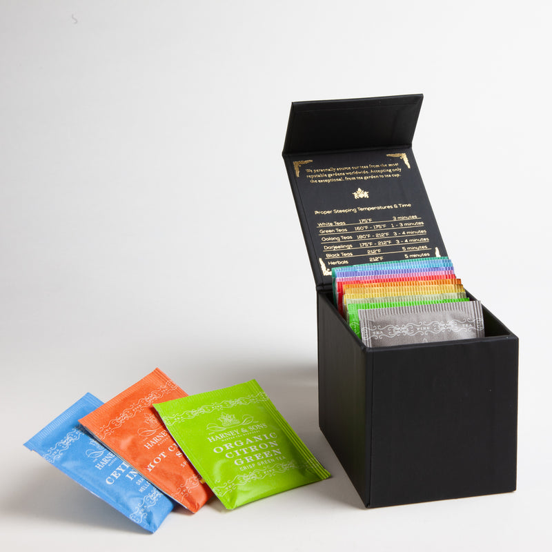 Harney Heritage Teabag Sampler: This colorful collection of fifteen premium teabags provides selection for any mood. Includes a mix of black, green, and herbal teas such as Raspberry, Lemon, Peppermint, Chamomile, English Breakfast, Earl Grey, Jasmine Green Tea, Chai, Ceylon, and Hot Cinnamon Spice. Packaged in a handsome black box with a magnetic closure.