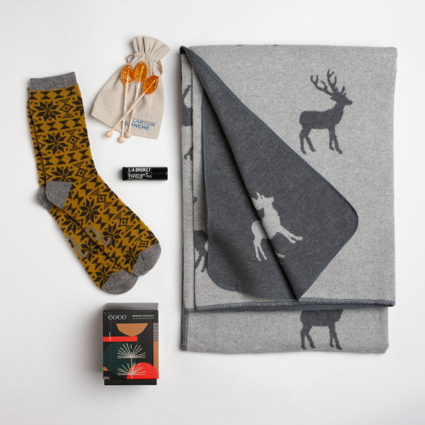 This cozy carton gives new meaning to the idea of a "wintry mix." A plush reindeer-patterned blanket from David Fussenegger combines with Fair Isle socks, salted caramel drinking chocolate, and soothing "Goodnight" lip balm to upgrade any winter nap.