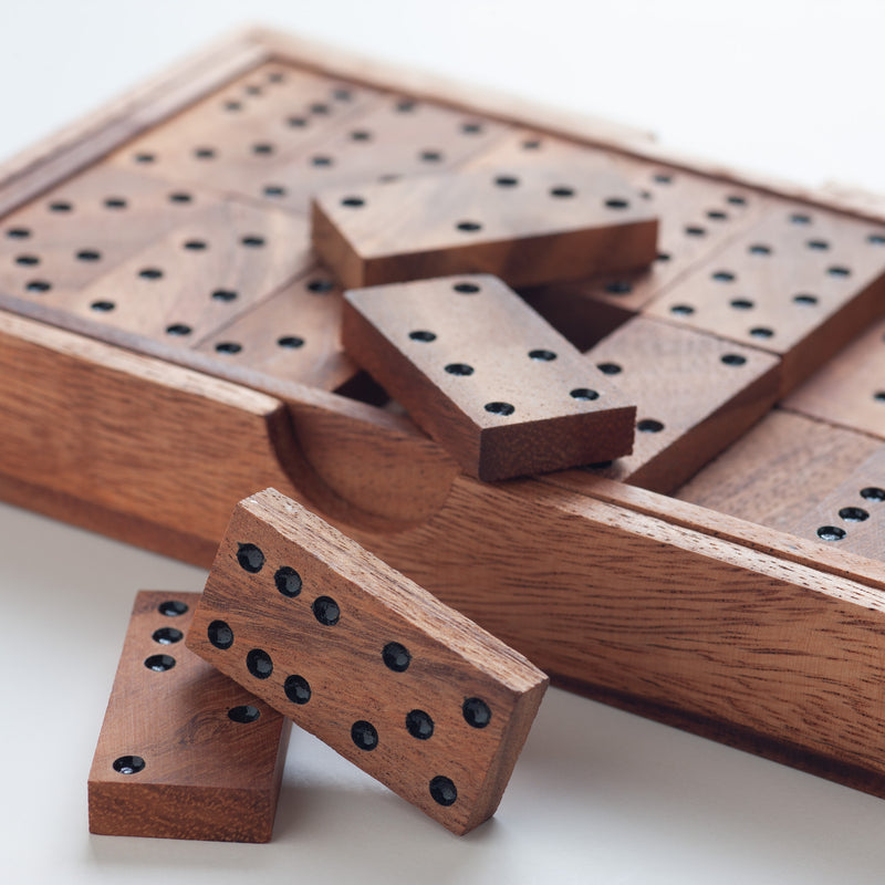 Wooden game pieces with black dots on a white background