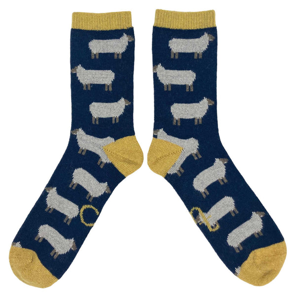 Made from naturally insulating lambswool, these whimsical socks are cozy enough for bedsocks and rugged enough to wear with boots.  Oatmeal sheep on navy base with lemon rib, heel and toe.