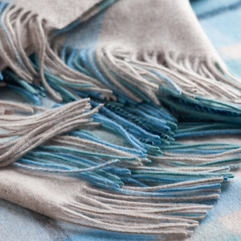 Lambswool throw: This glorious throw in shades of blue and oatmeal is as luxe as it looks. Lambswool is taken from the first shearing of the sheep, which makes for a very soft blanket. Size: 140 cm x 190 cm. Made in Britain