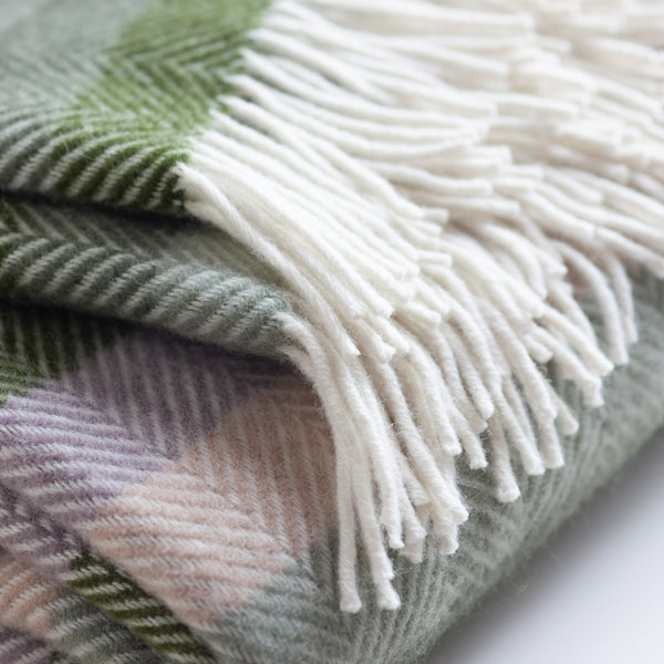 Pure new wool striped blanket in shades of the outdoors is made at a family-owned business in North Wales. This breathable wool will keep you warm in the winter and comfortable in the summer. Dimensions: 70 x 183 cm. Machine washable.