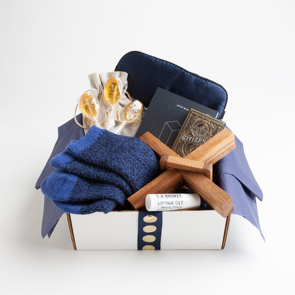 Soft but rugged alpaca socks, a classic deck of cards, moisturizing lip balm and a navy silk eye mask make recuperating as pleasant as possible.