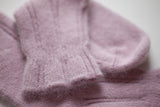 Close-up of mauve angora socks on a white background by Falke.