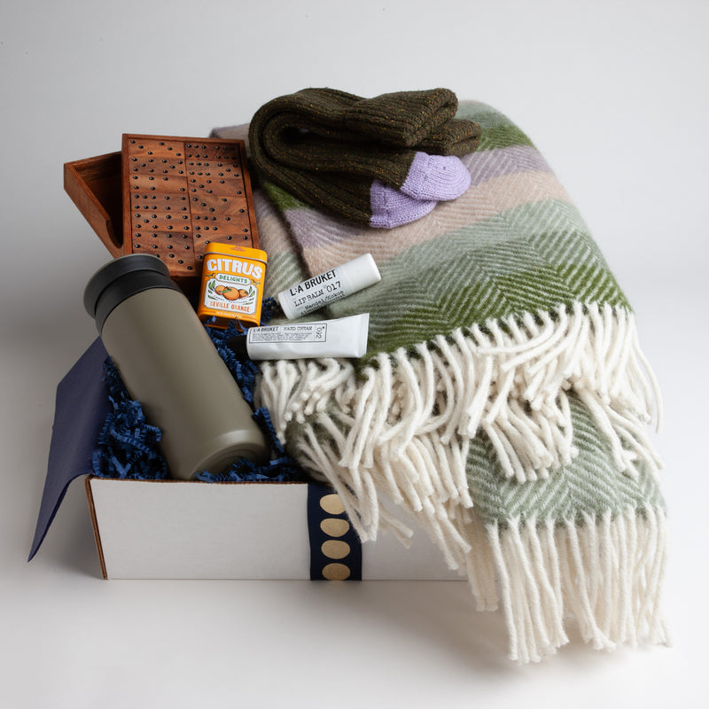 Botanical stripe throw by Tweedmill Textiles.  Pure new wool striped blanket in shades of the outdoors is made at a family-owned business in North Wales. This breathable wool will keep you warm in the winter and comfortable in the summer. Dimensions: 70 x 183 cm. Machine washable.