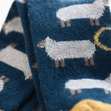 Lambswool socks by Catherine Tough:  These whimsical socks are cozy enough for bedsocks and rugged enough to wear with boots. Oatmeal sheep on navy base with lemon rib, heel and toe. 80% lambswool, 20% nylon polyamide for added durability, comfort and fit