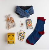 This cozy care package is built for the hero who's temporarily out of commission — whether they're fighting off a cold, recovering from surgery, or just in need of some serious downtime. Both loungers and wayfarers should enjoy these warm lambswool socks, heated neck wrap, technicolor Superman™ cards, and calming chamomile and lavender tea.