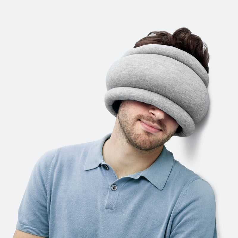 "Light Versatile Pillow" by Ostrich Pillow: a magical little pillow that provides comfort in myriad ways. Can be used as a head or neck pillow, an eye mask, or to make any challenging sleeping position more comfortable. Perfect for travel. Reversible and adjustable.