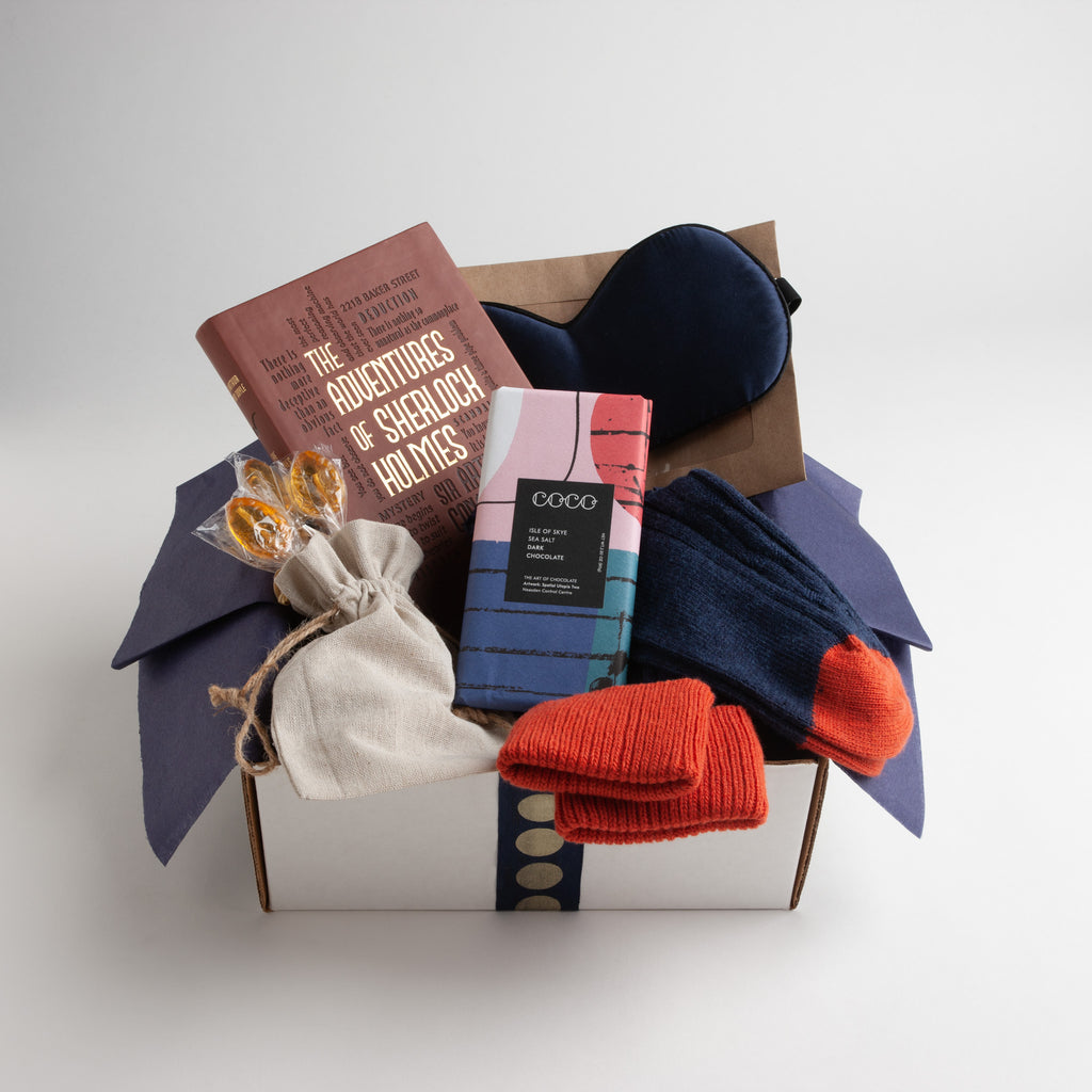 perfect get well gift for men includes The Adventures of Sherlock Holmes, soothing silk eye mask, indigo-striped socks with treads and a delicious dark chocolate bar