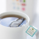A steaming cup of organic peppermint tea  by TeaLeaves.