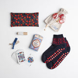 A pansy-patterned eye pillow, navy alpaca no-slip socks, rosy lip tint and a colorful deck of Beatles playing cards should make the recipient feel well-loved whether they are recuperating or studying for finals.