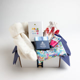 This nurturing gift includes a gorgeous floral eye pillow from Liberty of London, wild rose hand cream, coconut oil wipes, a selection of ten different teas and wool blend socks that define "walking on a cloud." .