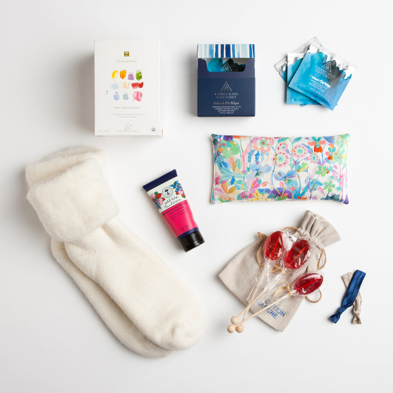 This nurturing gift includes a gorgeous floral eye pillow from Liberty of London, wild rose hand cream, coconut oil wipes, a selection of ten different teas and wool blend socks that define "walking on a cloud." .