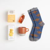 Cozy blue lambswool socks, Meyer lemon shortbread, a dark orange earthenware mug, clover honey, and soothing turmeric tea comprise the perfect prelude to a nap.