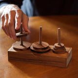 Towers of Hanoi:  Handsome wooden version of the logic game that has been challenging players since 1883. The object is to move the disks from one tower to the other without placing a larger disk onto a smaller one. Made out of eco-friendly monkey pod wood.