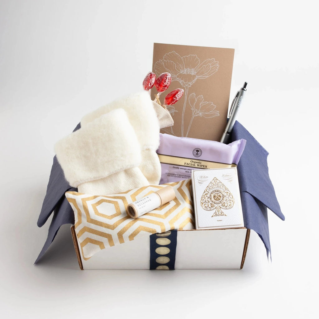 Carton Ivory - This carton is brimming with get-well essentials that will lift any patient's comfort level up a notch. A lavender-scented eye pillow, ridiculously cozy socks, rosy lip tint, organic facial wipes, elegant playing cards, and more, round out our best-selling care package.