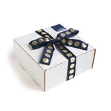 All of our get well gifts come in our trademark white carton tied up with a festive navy and metallic gold dotted ribbon.