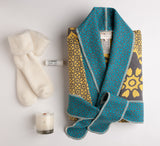 Striking yellow, grey and turquoise plush cotton kimono by David Fussenegger, white fluffy socks, LA Bruket lip balm and a deliciously-scented guava fig candle by Simply Curated make for an extraordinary gift.